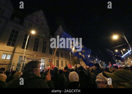 Gdansk, Poland. 18th Dec, 2019. People with Polish and EU flags protesting in front of Court are seen in Gdansk, Poland on 18 December 2019People gathered in over 180 Polish cities to protest against a proposal by the ruling Law and Justice nationalists party, that would allow for judges to be punished and even fired if they question the legitimacy of the government's judicial reforms and, if they will apply European Union laws. Credit: Vadim Pacajev/Alamy Live News Stock Photo