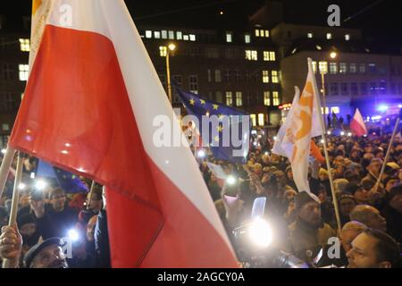 Gdansk, Poland. 18th Dec, 2019. People with Polish and EU flags protesting in front of Court are seen in Gdansk, Poland on 18 December 2019People gathered in over 180 Polish cities to protest against a proposal by the ruling Law and Justice nationalists party, that would allow for judges to be punished and even fired if they question the legitimacy of the government's judicial reforms and, if they will apply European Union laws. Credit: Vadim Pacajev/Alamy Live News Stock Photo