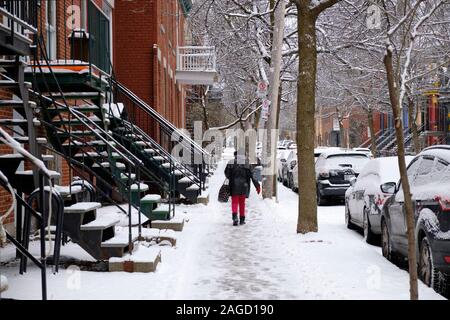 Montreal, Quebec, Canada. December 18th, 2019. Colourful house along St-Louis square (Carré Saint-Louis) in the plateau neighbourhood of Montreal, with current slippery sidewalks as winter conditions hit the city. Snow has been falling all day, with total accumulation expect to reach 7-10cm by midnight, by which time the temperatures are expected to drop to -15 Celsius. Stock Photo