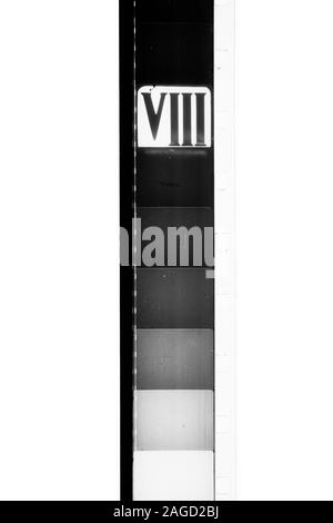Detail of super 8 mm film strip scratched black and white movie tail leader countdown number eight roman numerals cinema background Stock Photo