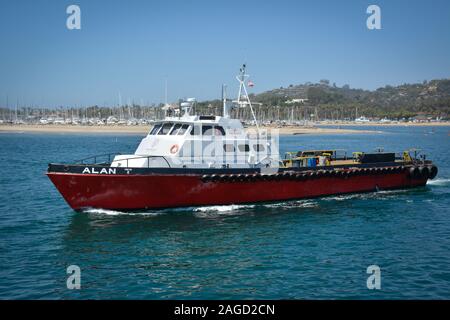 A 100 ft triple diesel screw aluminum crew boat, the 'Alan T', a So Cal Ship Services boat, cruising through the Santa Barbara harbor in Southern Cali Stock Photo