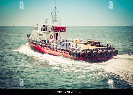 A 100 ft triple diesel screw aluminum crew boat, the 'Alan T', a So Cal Ship Services boat, leaving the Santa Barbara harbor towards the Pacific Ocean Stock Photo