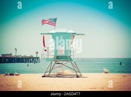 People sunbathing on beach near Sterns Wharf at the Aqua blue lifeguard stand #3 in Santa Barbara, CA, USA Stock Photo