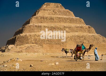 NOVEMBER 12, 2019, CAIRO, EGYPT - Sakkara Pyramid known as 'Step Pyramid' first pyramid of Egypt with Camel and Moslem man Stock Photo