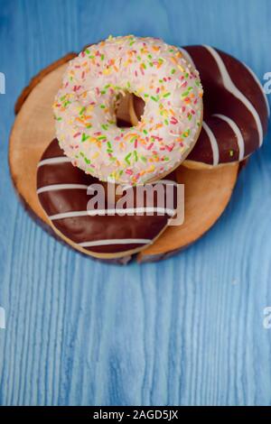 donuts lying on the table. blue background. Stock Photo