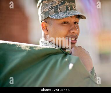 Portrait of a smiling soldier carrying a bag over his shoulder. Stock Photo