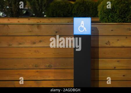 sign the disabled person. lighting in the Parking lot at night . minimalist eco Stock Photo
