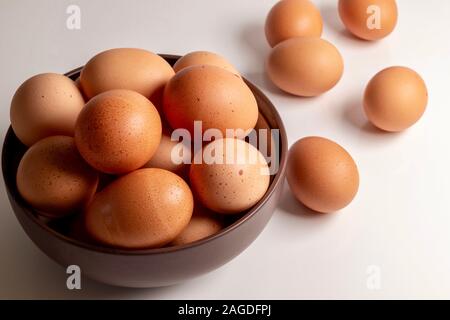 bowl of brown eggs on white background Stock Photo