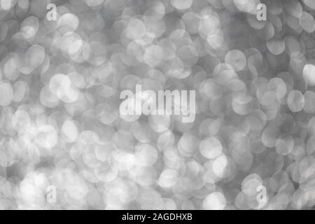 Silver abstract bokeh background. Silver Christmas texture. Defocused shiny sequins. Stock Photo