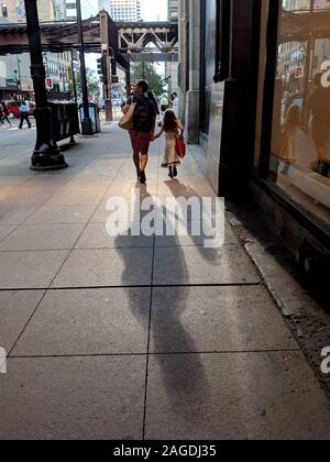 A father and daughter walking in downtown Chicago Stock Photo