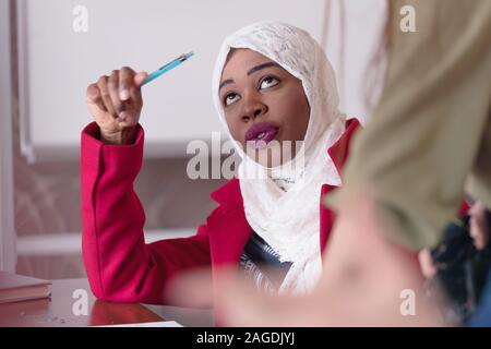 Two multiethnic female startup business african american and european woman working everyday job at modern coworking office space looking at innovativ Stock Photo