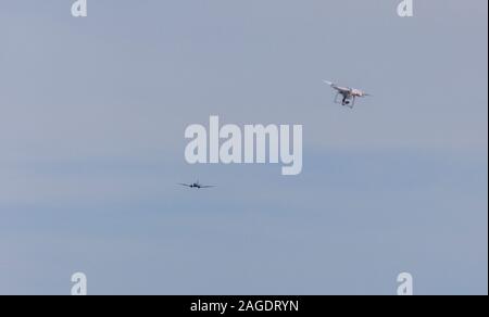 Out of focus drone in air with in-focus aircraft in background. Stock Photo