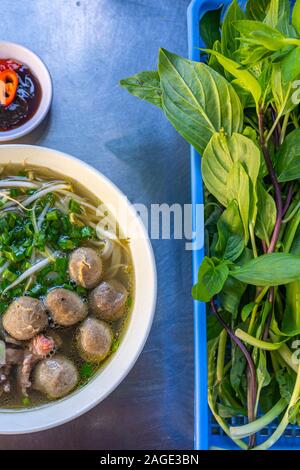 Special angle photo of Vietnamese Pho bowl and fresh vegetable Stock Photo