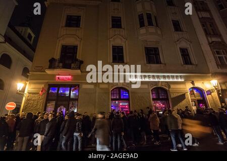 PRAGUE, CZECHIA - NOVEMBER 1, 2019: Crowd of people queuing in front of Chapeau Rouge at night. Chapeau Rouge is one of the main night clubs and danci Stock Photo