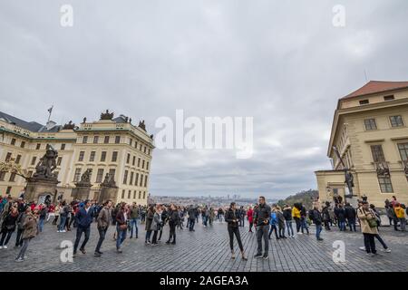 PRAGUE, CZECHIA - NOVEMBER 2, 2019: Hradcanske namesti square, on the Hradcany hill, in Prague castle, packed with a crowd of tourists visiting this i Stock Photo