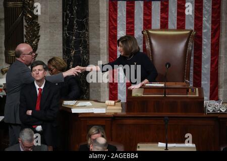 Washington, United States. 18th Dec, 2019. U.S. Speaker of the House Nancy Pelosi (D-CA) shakes hands with House Rules Committee Chairman Rep. Jim McGovern (D-MA) as she presides over the House of Representatives vote on a second article of impeachment against U.S. President Donald Trump in the House Chamber of the U.S. Capitol in Washington, U.S., on Wednesday, December 18, 2019. Pool photo by Jonathan Ernst/UPI Credit: UPI/Alamy Live News Stock Photo