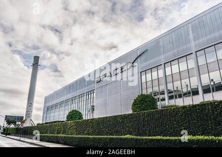 Dec 8, 2019 Hawthorne / Los Angeles / CA / USA - SpaceX (Space Exploration Technologies Corp.) headquarters; Falcon 9 rocket displayed on the left; Sp Stock Photo