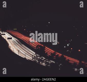 High angle shot of two parallel highways with red and white lights at night Stock Photo