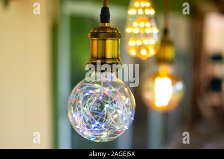 Classic retro incandescent led electric lamp warm white on blur background, Vintage light bulb Stock Photo