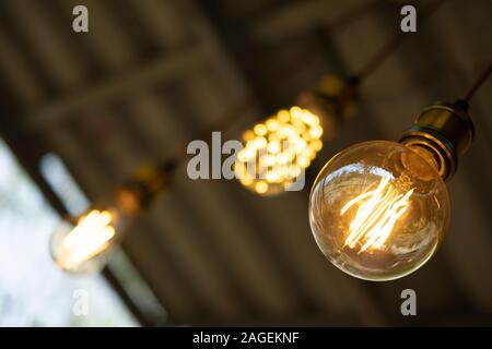 Classic retro incandescent led electric lamp warm white on blur background, Vintage light bulb Stock Photo