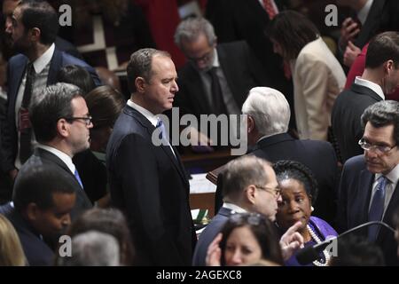 Washington, District of Columbia, USA. 18th Dec, 2019. United States Representative Adam Schiff (Democrat of California), Chairman, US House Permanent Select Committee on Intelligence, center, chats with colleaguesSpeaker of the United States House of Representatives Nancy Pelosi (Democrat of California) presides over Resolution 755, Articles of Impeachment Against US President Donald J. Trump as the House votes at the US Capitol in Washington, DC, on December 18, 2019. - The US House of Representatives voted 229-198 on Wednesday to impeach US President Donald J. Credit: ZUMA Press, Inc./Alamy Stock Photo