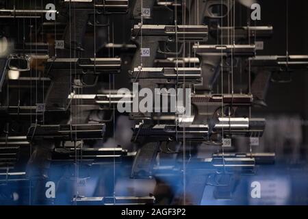 Oberndorf Am Neckar, Germany. 18th Dec, 2019. Pistols hang in a showcase in the museum of the weapons manufacturer Heckler & Koch. Credit: Marijan Murat/dpa/Alamy Live News Stock Photo