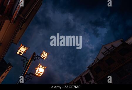 Brightly lit lamppost on the street in Wulingyuan after dusk at night, Hunan Province, China Stock Photo