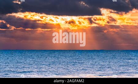 Sun bursting through storm clouds at sunset, Santa Cruz, California Stock Photo