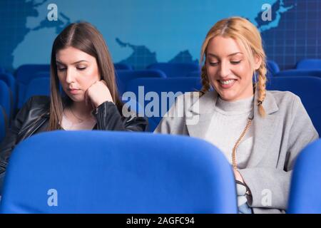 Two female young economy  university students  listening and watching business presentation for startup business at conference meeting room. Stock Photo