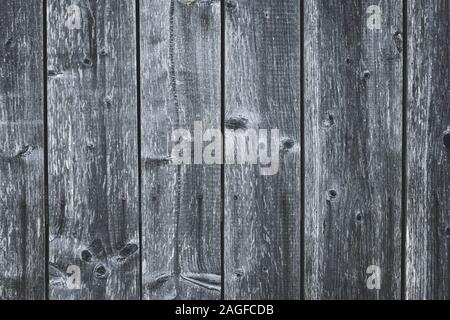 Dark gray wood fence. Shabby table. Old grey wooden boards. Pattern of cracked planks. Strips on wood surface. Dilapidated boards with nails. Grunge t Stock Photo