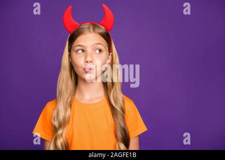 Photo of pretty little lady headband horns on head looking empty space sending air kiss classmate boy helloween party wear orange t- shirt isolated Stock Photo