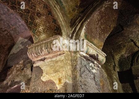 Ethiopia, Amhara Region, Lalibela, Arbatu Ensessa, Biblia Chirkos, ancient rock hewn church, water-damaged interior, ancient frescoes above arch Stock Photo