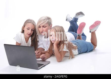 mom and daughters watching their favorite video on a laptop Stock Photo