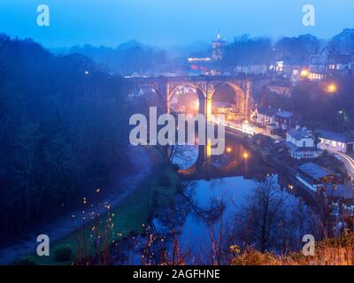 The railway viaduct over the River Nidd at dusk on a misty evening Knaresborough North Yorkshire England Stock Photo