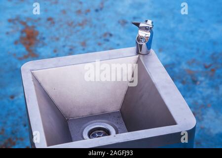 Modern drinking water tap with metal sink outdoor Stock Photo