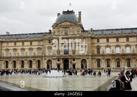 PARIS, FRANCE - 04 OCTOBER, 2019: People visiting Louvre Museum with Louvre Pyramid Stock Photo