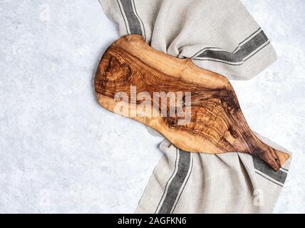 beautiful wooden kitchen background cutting board over kitchen towel on white table background, top view Stock Photo