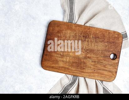 beautiful wooden kitchen background cutting board over kitchen towel on white table background, top view Stock Photo