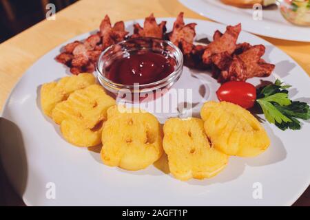 Child food. Funny food. Plate with cutlets and mashed potatoes in the form of a monkey faces. Children's menu Stock Photo