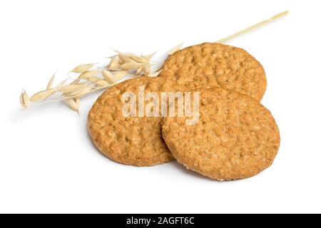 Crunchy healthy oat cookies and an ear of dried oat isolated on white background Stock Photo