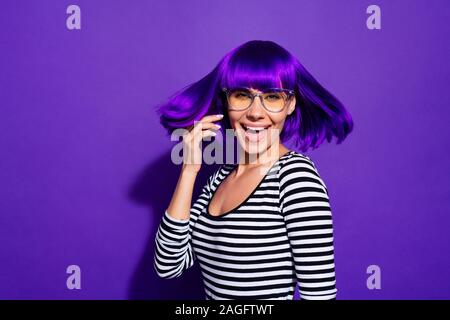 Portrait of nice millennial screaming shouting wearing striped shirt isolated over purple violet background Stock Photo
