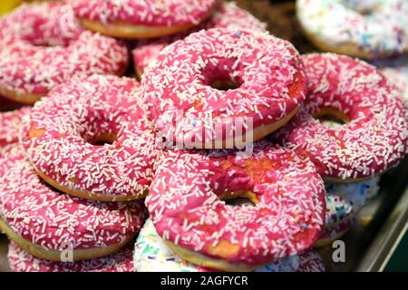 Display of traditional doughnuts on sale at christmas market stall Stock Photo