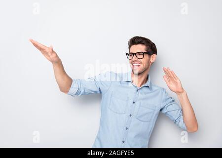 Photo of cheerful attractive handsome resting man dancing smiling toothily wearing eyeglasses isolated over grey color background Stock Photo
