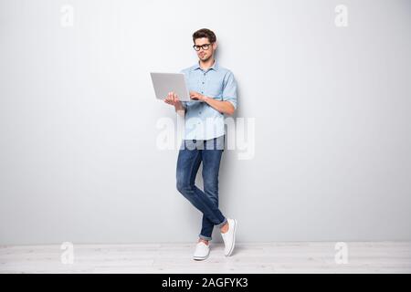 Full length body size photo of focused serious intelligent coworking manager standing confidently with legs crossed searching for news via internet Stock Photo