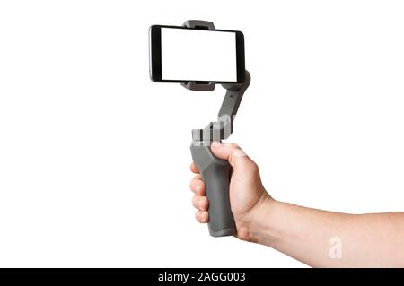 Man filming with a blank screen smartphone using a gimbal stabilizer, isolated on white background Stock Photo