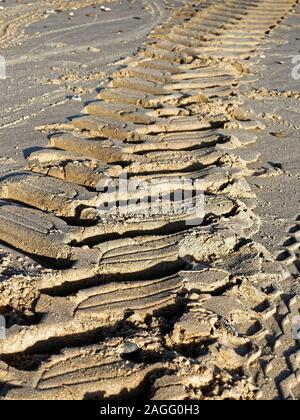 Tracks in the sand - tyre marks left by a fisherman's tractor on a beach in Norfolk. Stock Photo