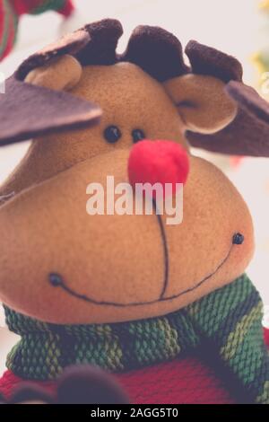 Festive deer soft toy, happy smiling face close-up. Stock Photo
