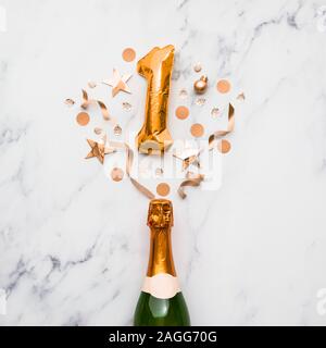 Champagne bottle with gold number 1 balloon. Minimal party anniversary concept Stock Photo