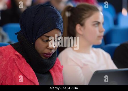 African american muslim  business woman listening and watching presentation for business people with her friends. Multiracial and multiethnic business Stock Photo