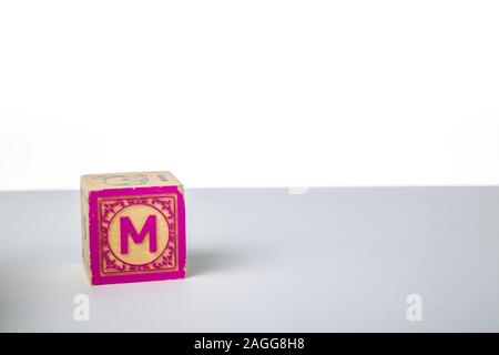 Childrens Wooden Alphabet Block Showing the Letter M Stock Photo